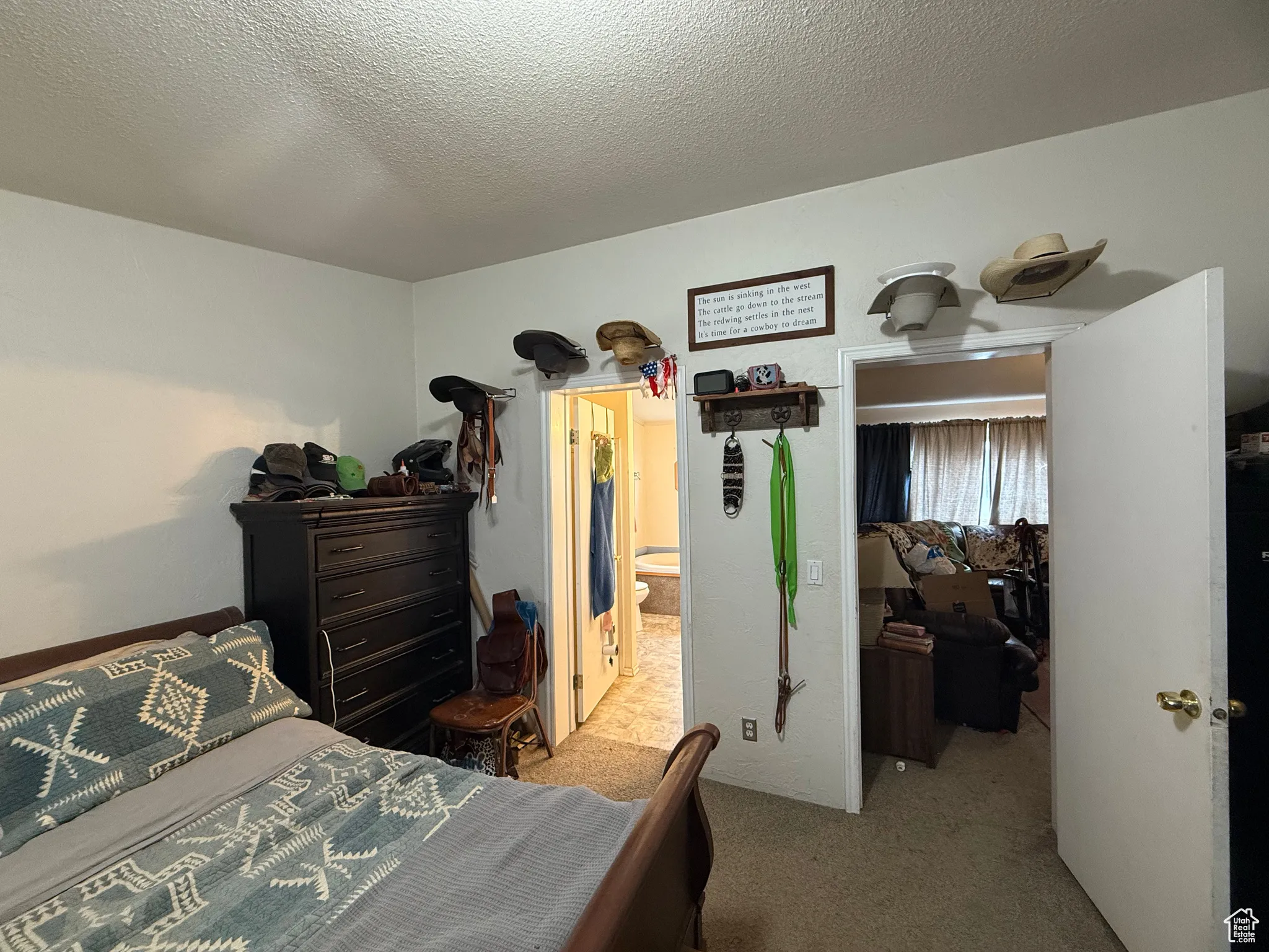 Carpeted bedroom featuring a textured ceiling