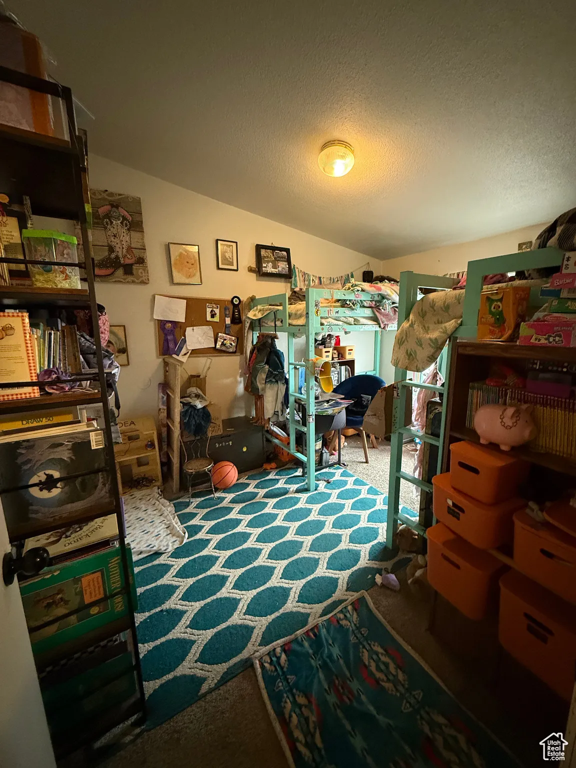 Bedroom with lofted ceiling, carpet floors, and a textured ceiling