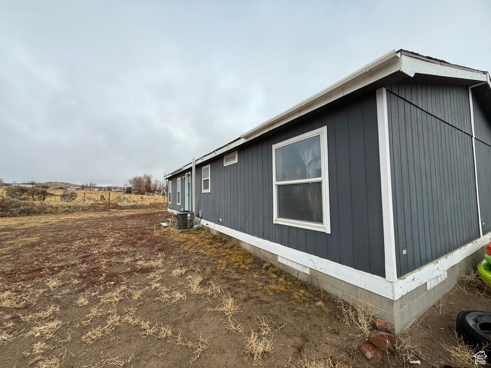 View of side of home with central AC unit