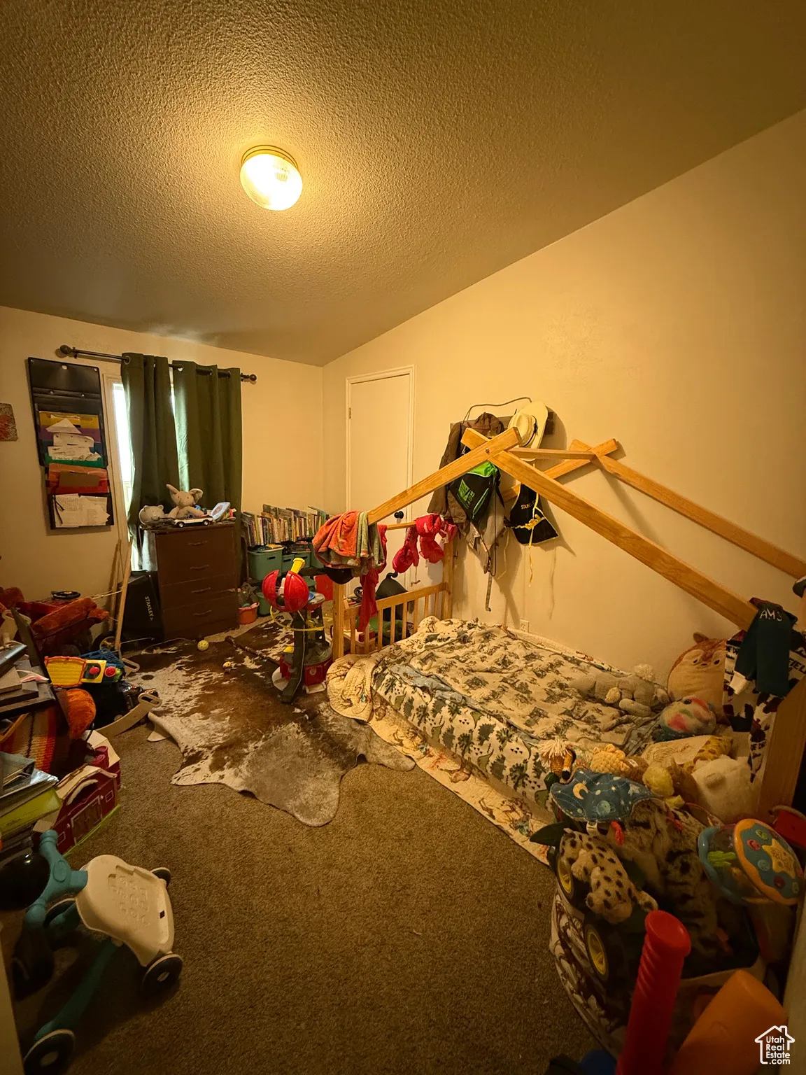 Carpeted bedroom with a textured ceiling