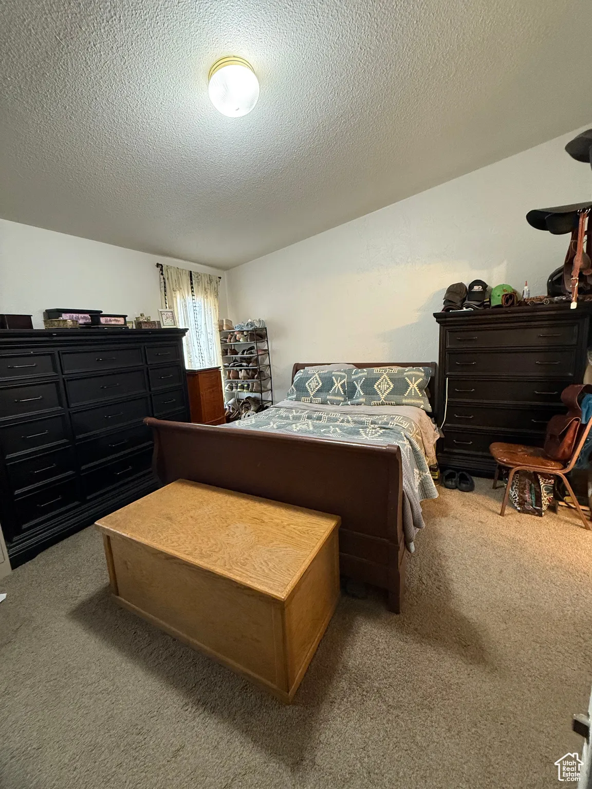 Bedroom featuring carpet floors and a textured ceiling