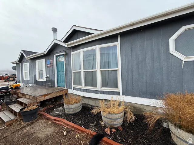 View of home's exterior with a wooden deck