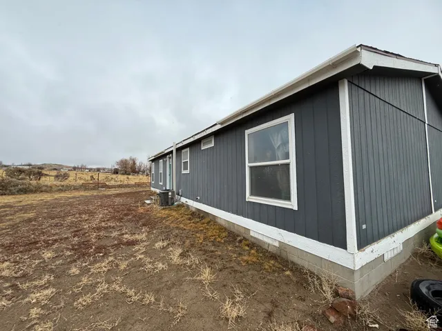 View of side of home with central AC unit