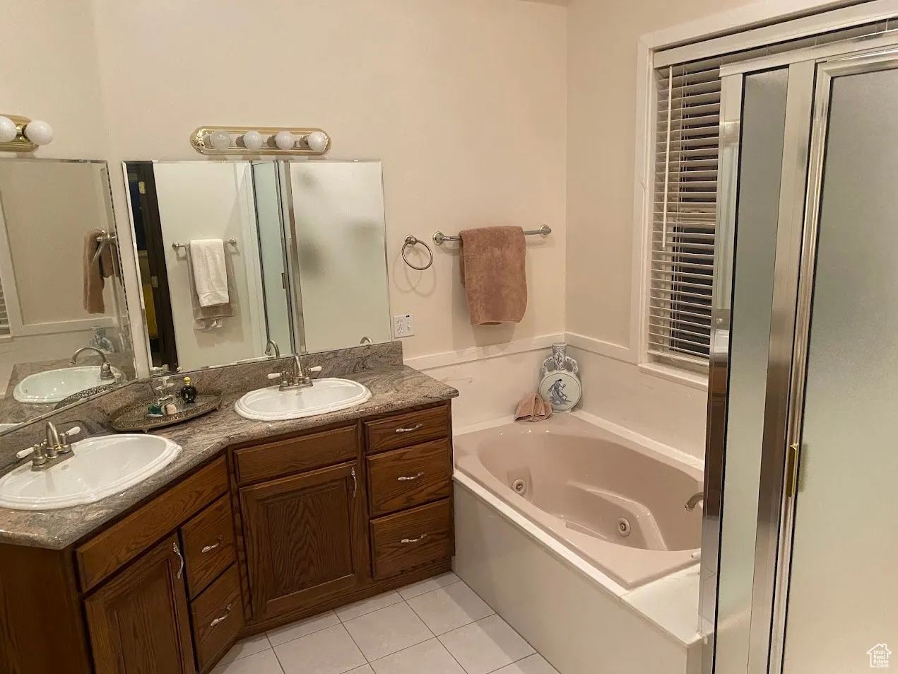 Primary Bathroom with jetted tub and shower and double sinks