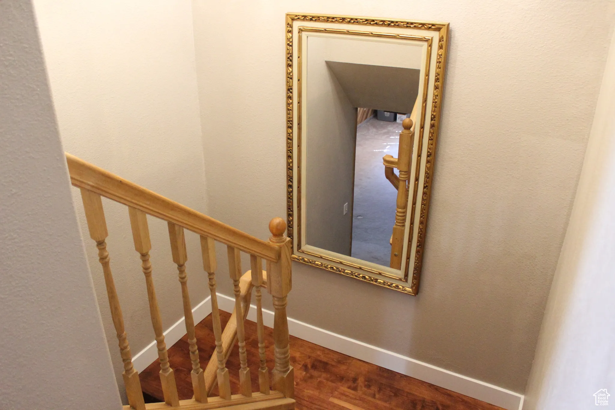 Stairs with baseboards and wood finished floors