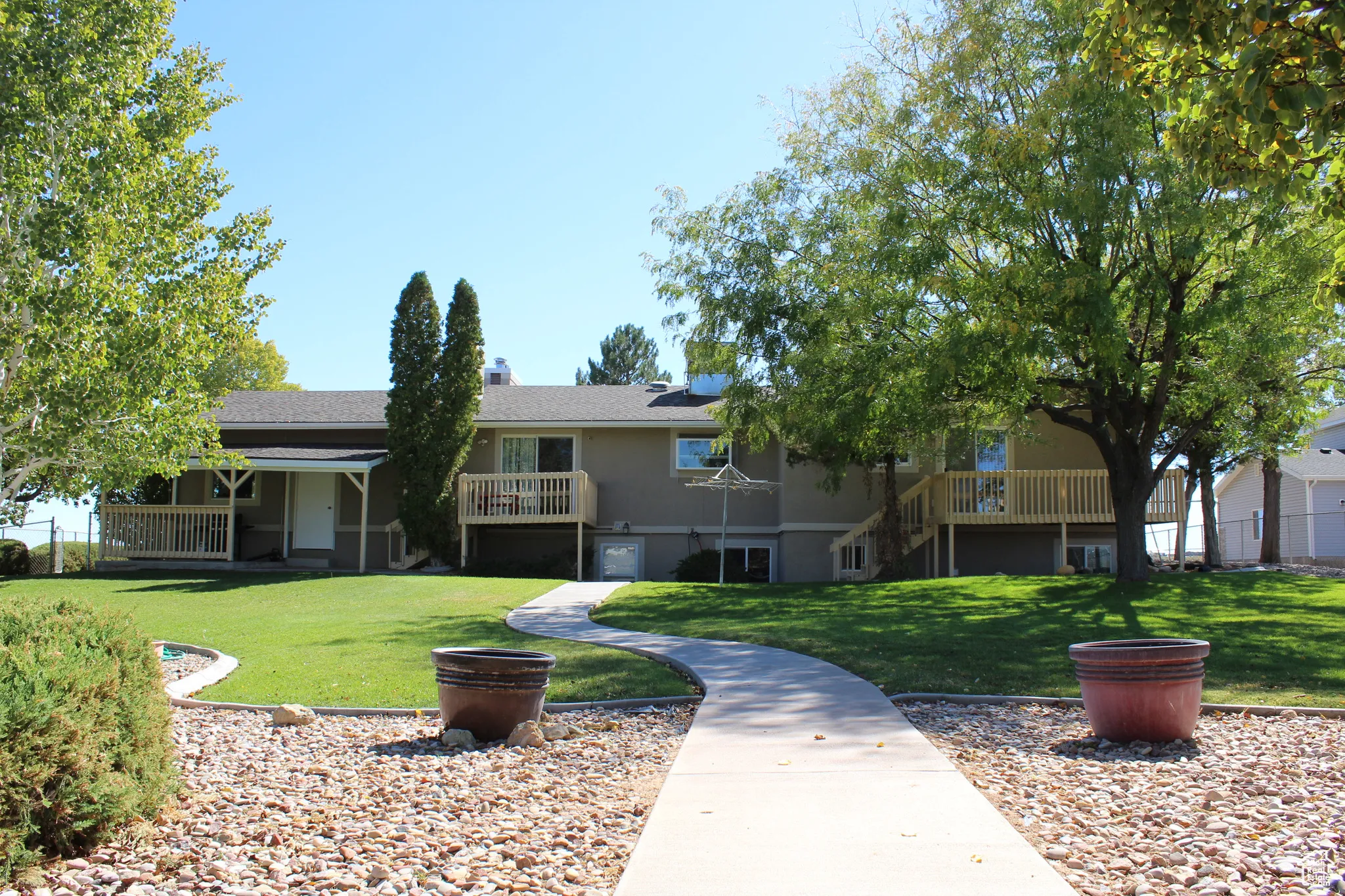 View of home's community with a lawn, stairs, and a wooden deck