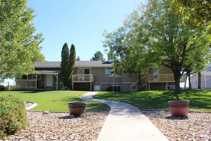 View of home's community with a lawn, stairs, and a wooden deck