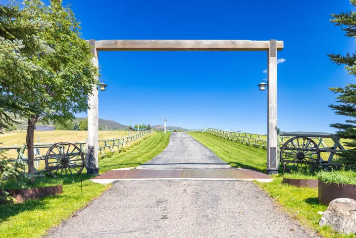 Gated entry with a substantial wood archway and integrated lanterns
