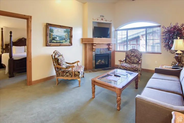 Living room with a tiled fireplace and carpet floors