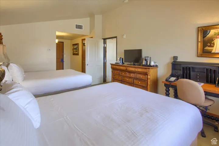 Bedroom featuring lofted ceiling