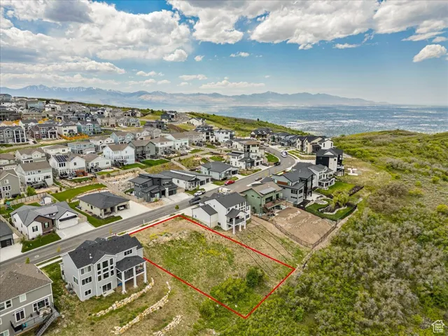 Aerial view of residential area featuring property parcel outlined and a water and mountain view