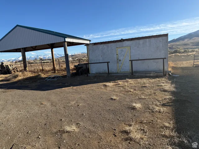 View of outbuilding featuring a rural view and a mountain view