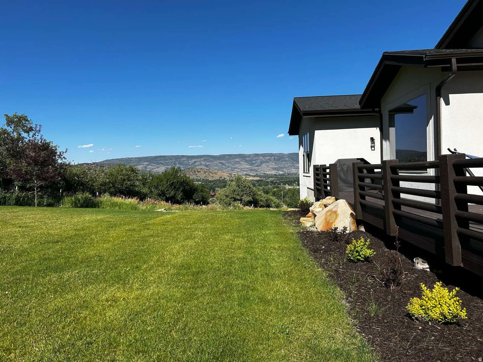 Expansive lawn area with a mountain backdrop