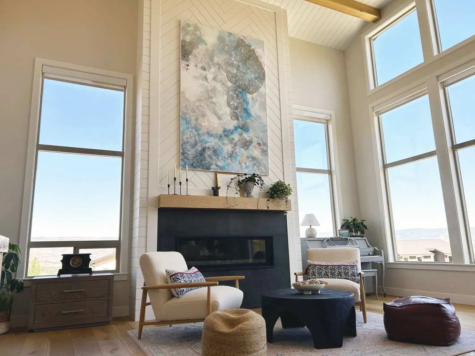 Living area featuring a tall fireplace with a dark surround and a light wood mantel