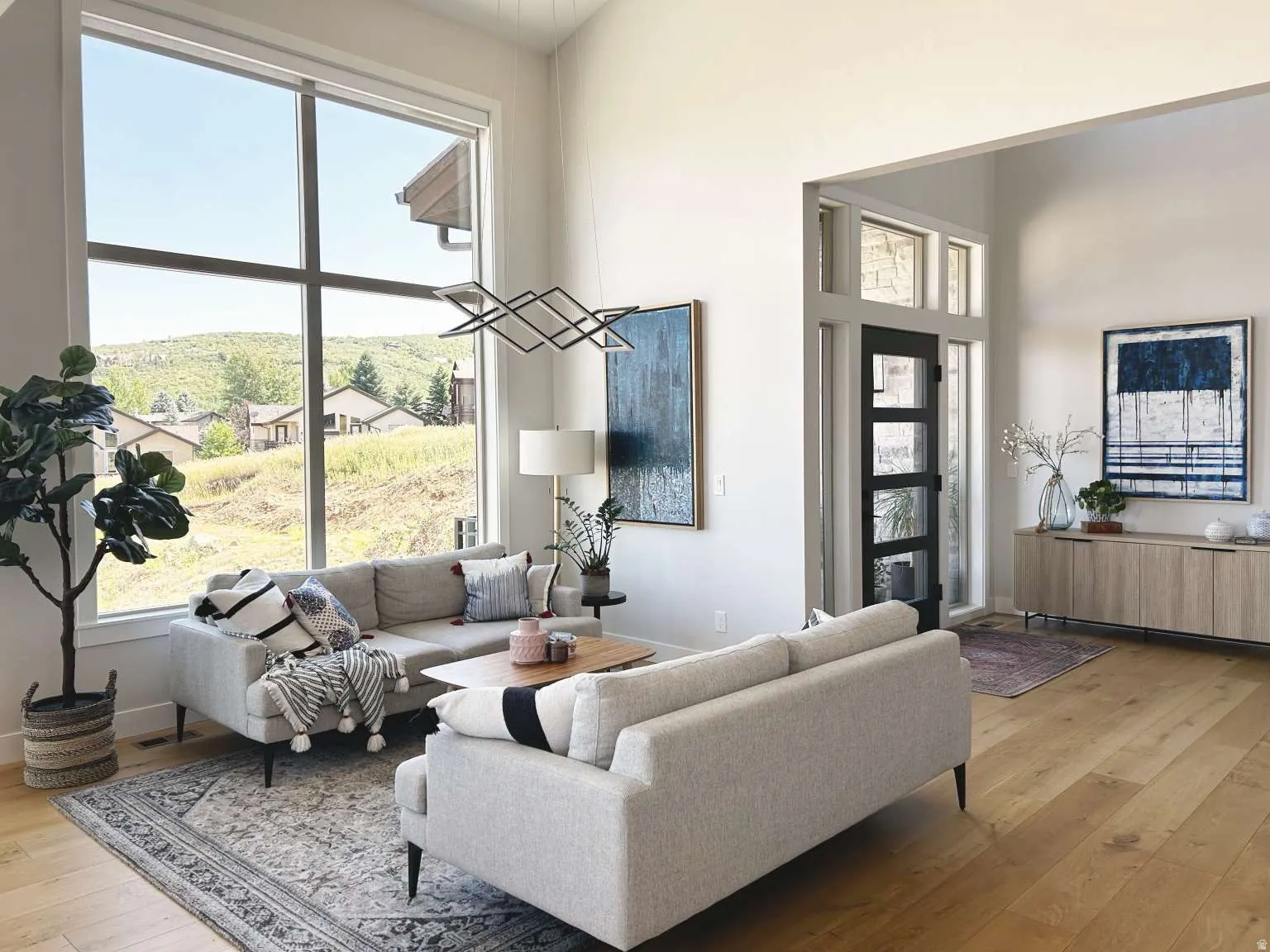 Living area featuring soaring ceilings and expansive windows