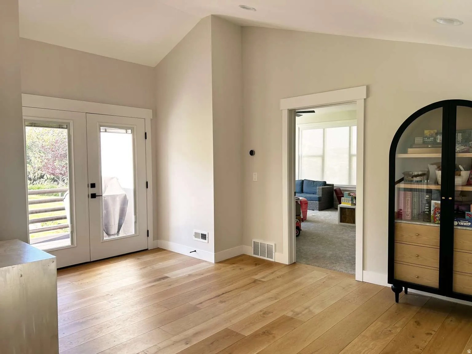 Light wood-finish flooring complements neutral wall tones throughout this space