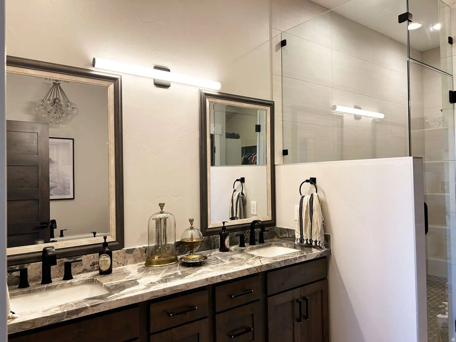 Double vanity with undermount sinks and dark wood cabinetry