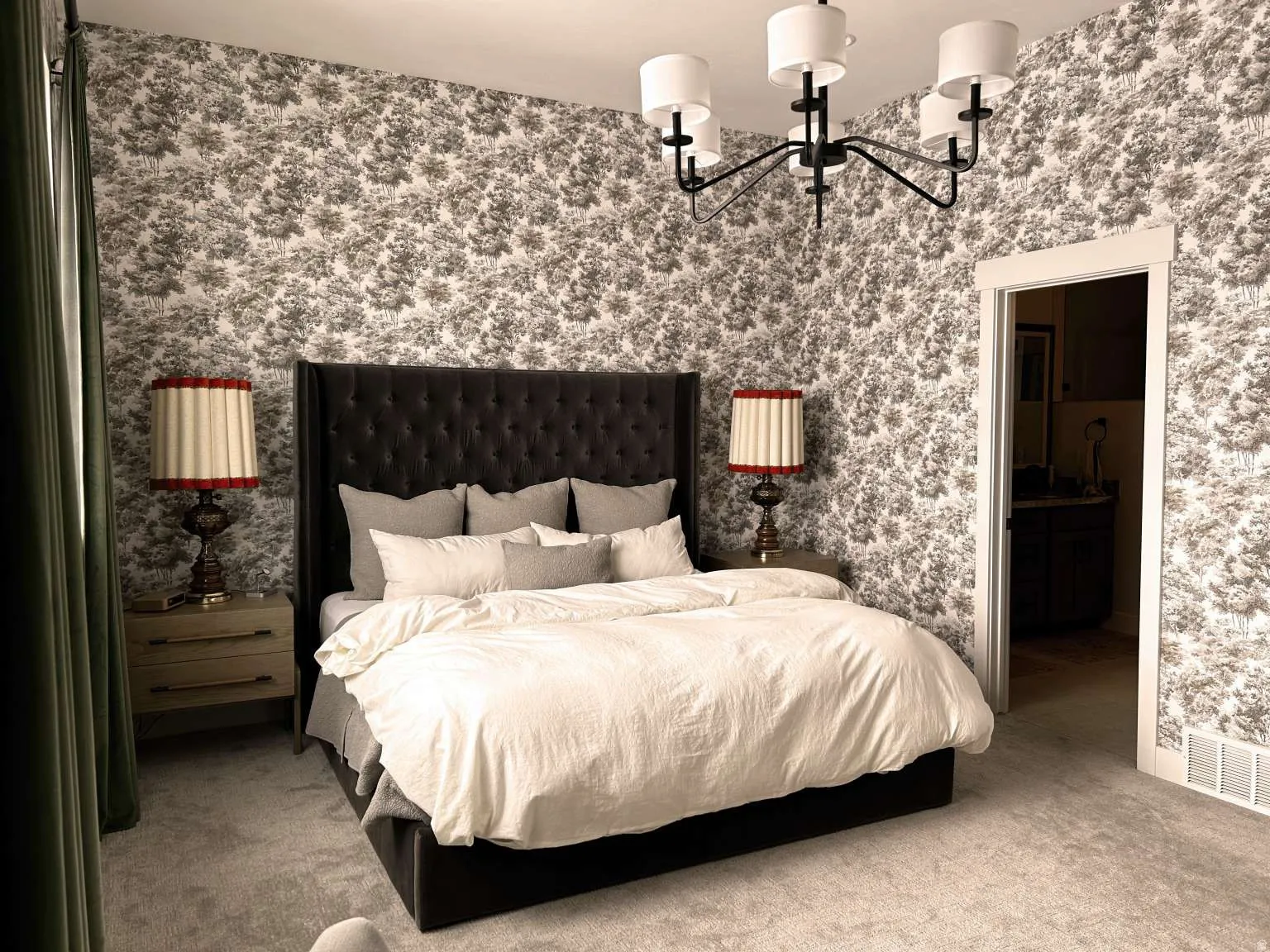 Bedroom featuring patterned wallpaper, carpeted flooring, and a modern chandelier