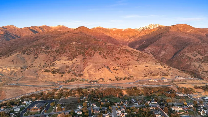 View of mountain backdrop featuring nearby suburban area