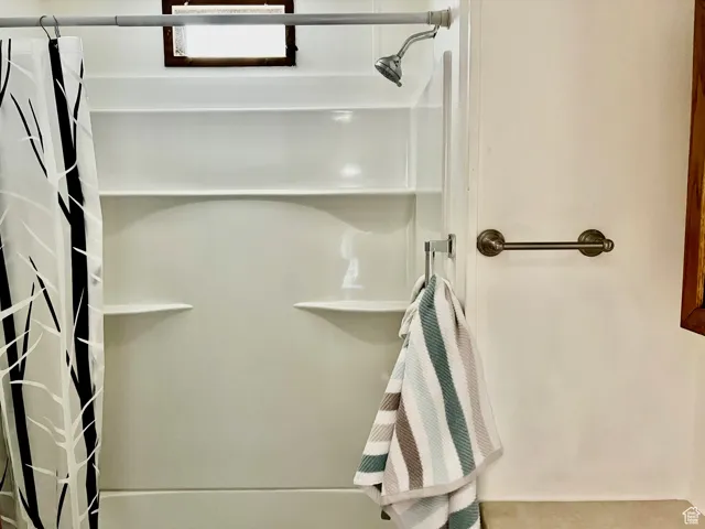 Bathroom featuring curtained shower