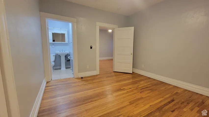 # 9 Unfurnished bedroom featuring light wood-style floors and ensuite bathroom