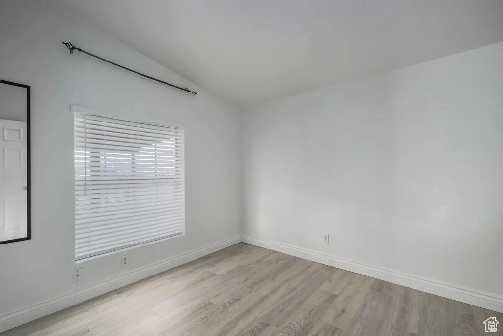 Unfurnished room with baseboards and light wood-style floors