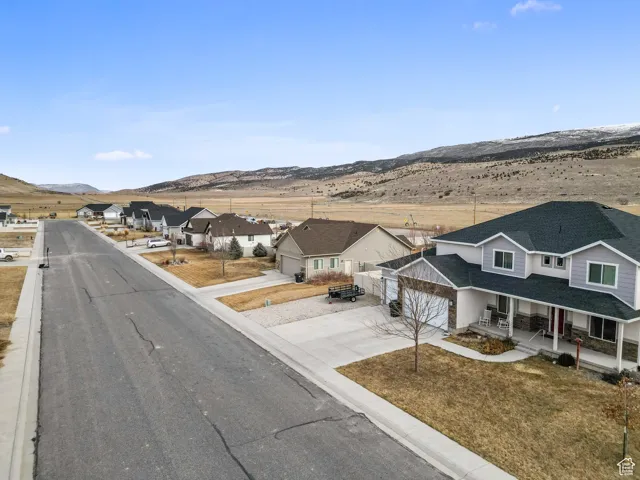 View of street featuring a residential view, a mountain view, and curbs