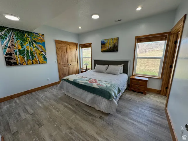 Primary Bedroom featuring baseboards, and wood finished floors