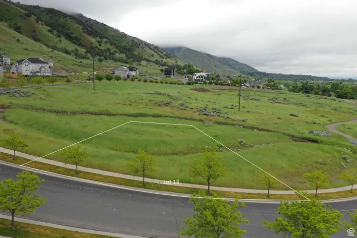 Aerial view of sparsely populated area featuring a pastoral area and a mountainous background