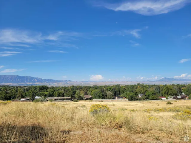 View of mountain backdrop featuring rural landscape