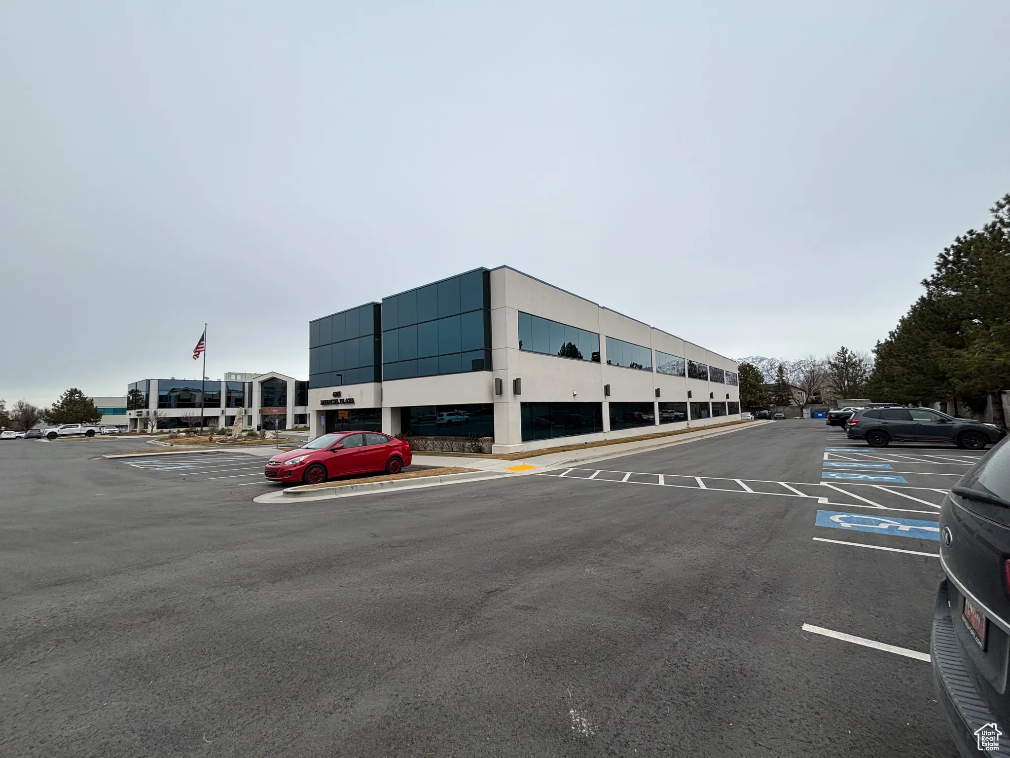 View of building exterior featuring uncovered parking