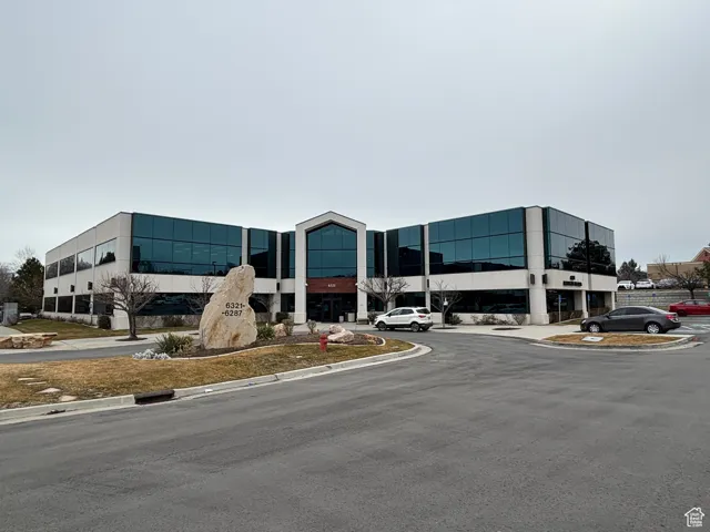 View of property featuring uncovered parking