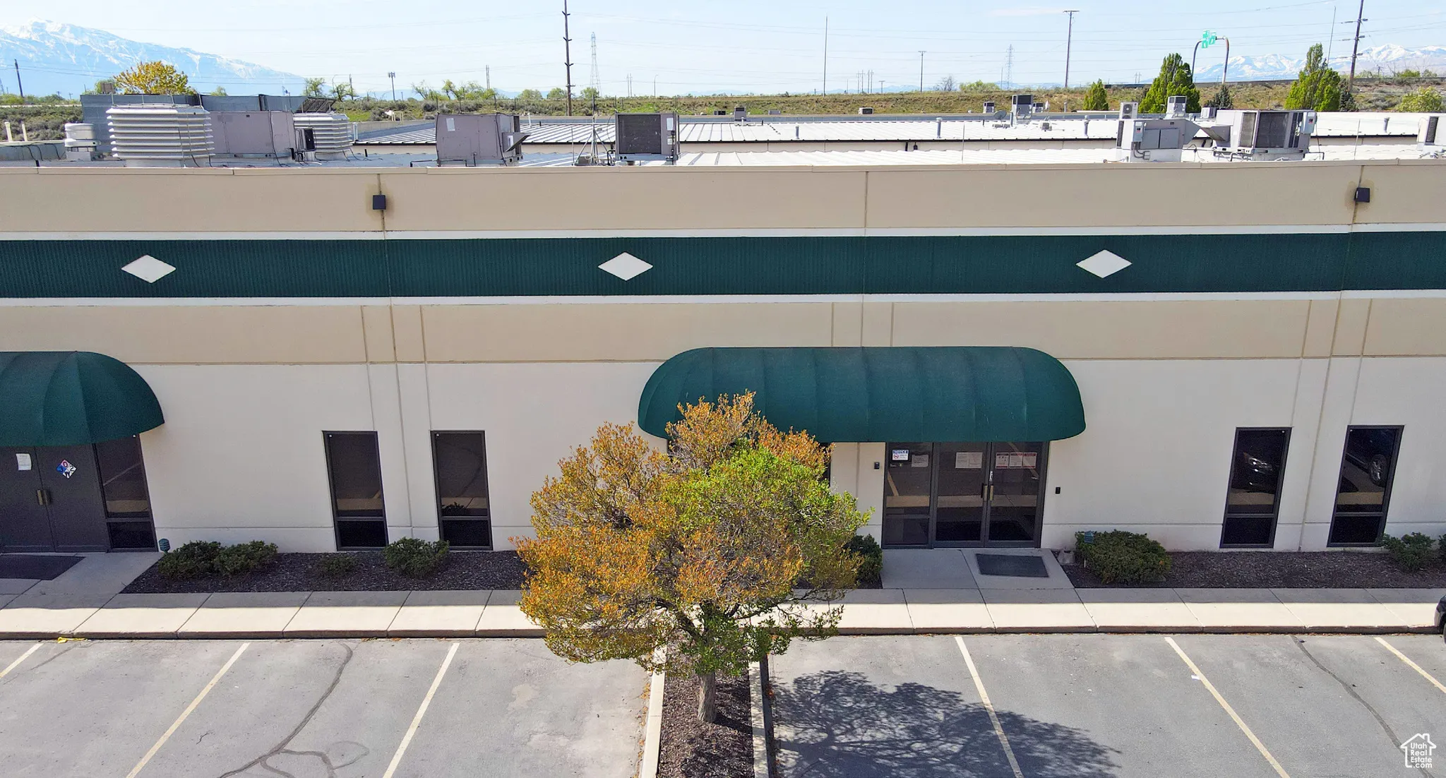View of building exterior featuring uncovered parking