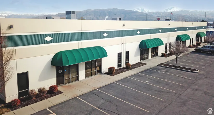 View of building exterior featuring uncovered parking and a mountain view