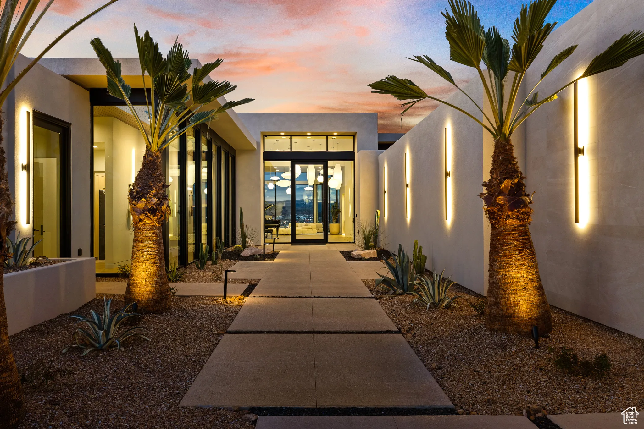 Exterior entry at dusk featuring stucco siding