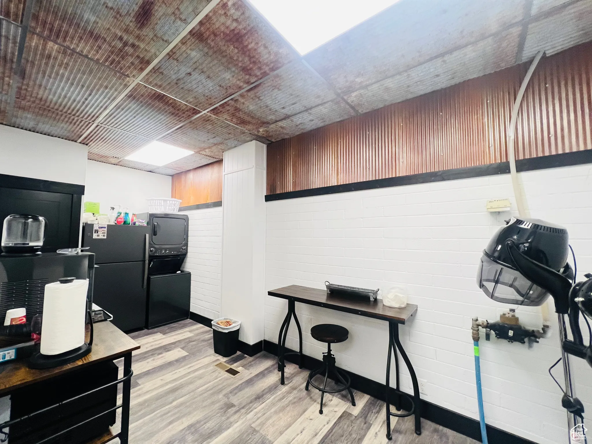 Kitchen with light wood-type flooring and freestanding refrigerator
