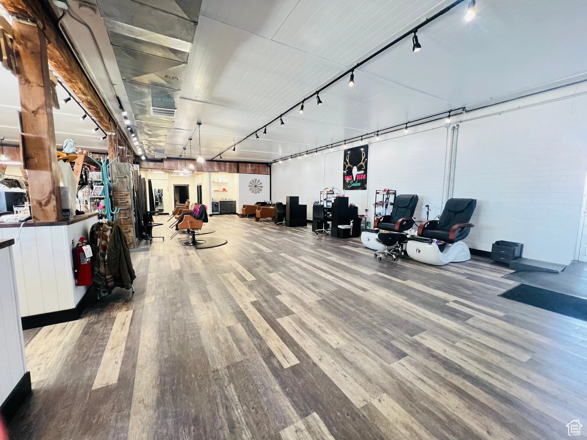 Miscellaneous room with track lighting and wood finished floors