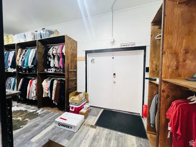 Walk in closet with wood finished floors