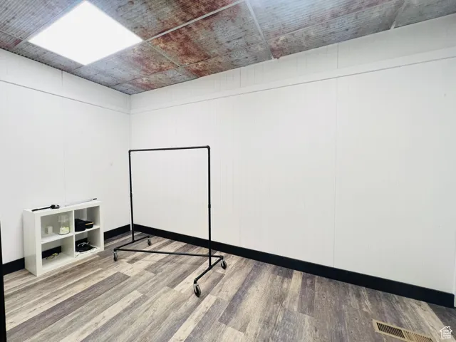 Basement featuring wood finished floors and baseboards