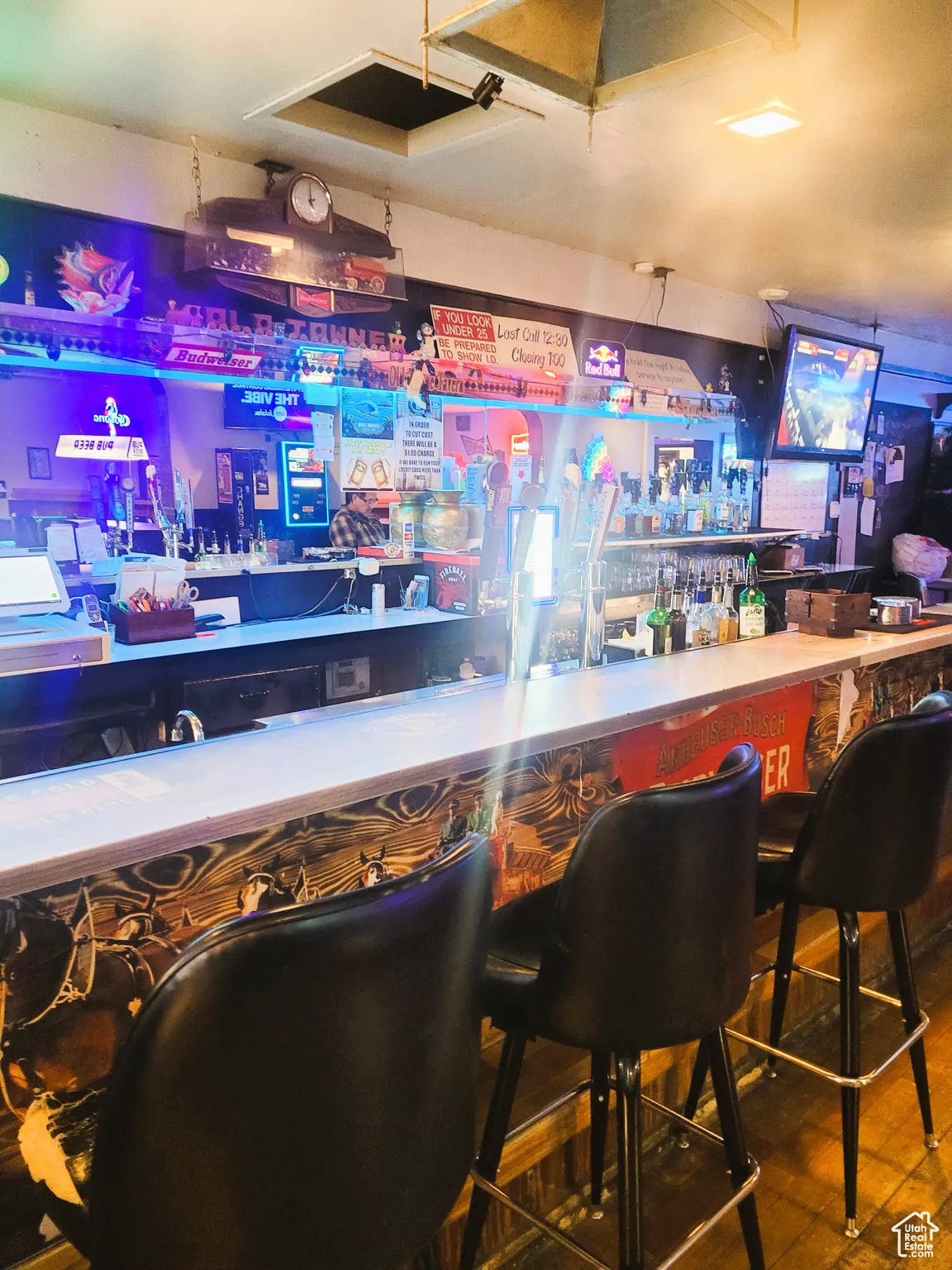 Bar with a dry bar and wood finished floors