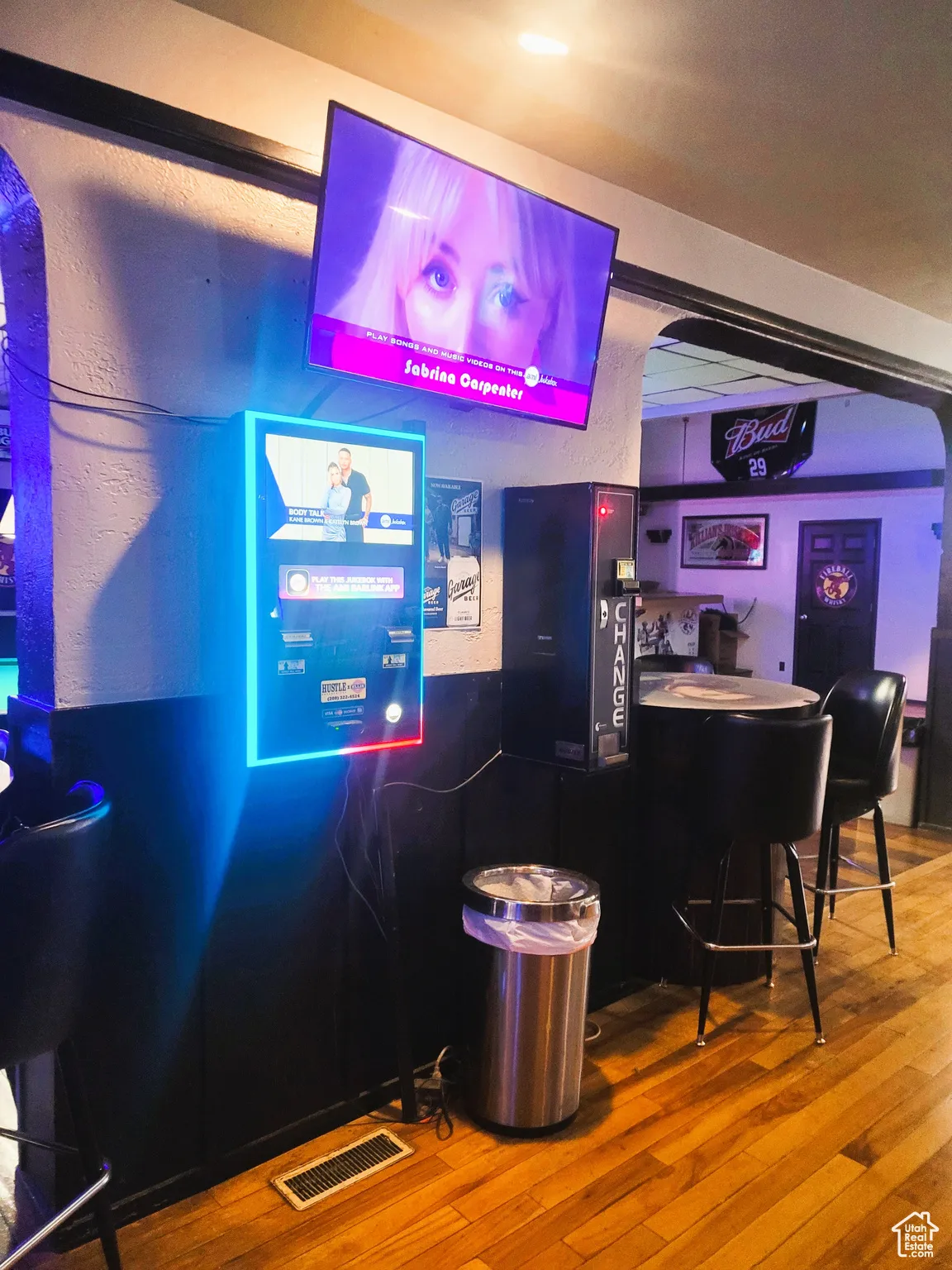 Bar with a bar, wood-type flooring, and visible vents