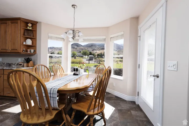 Dining space featuring stone finish flooring and a chandelier