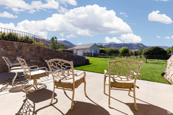 Fenced backyard with a mountain view and a patio