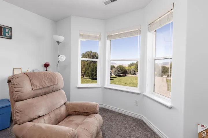 Sitting room featuring carpet and baseboards