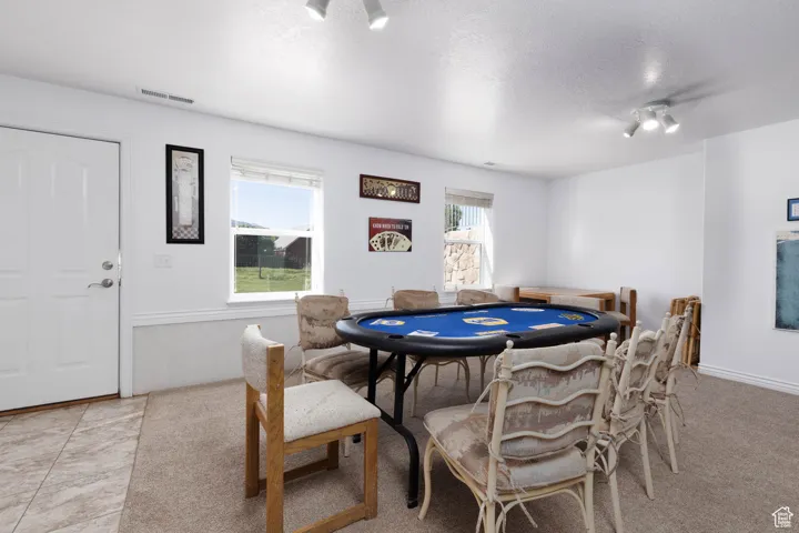 Playroom with a textured ceiling and light colored carpet