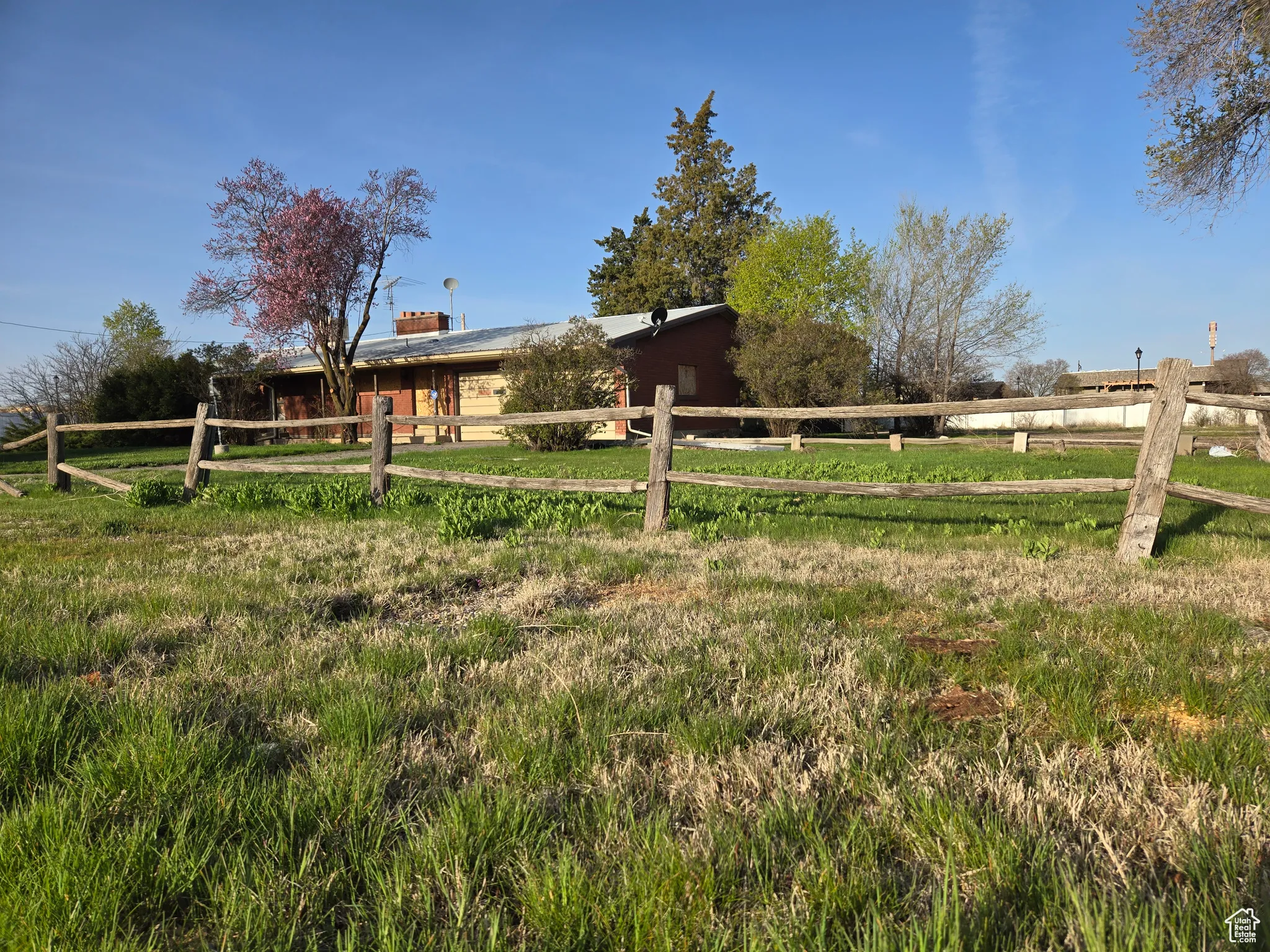 View of yard with a rural view and fence