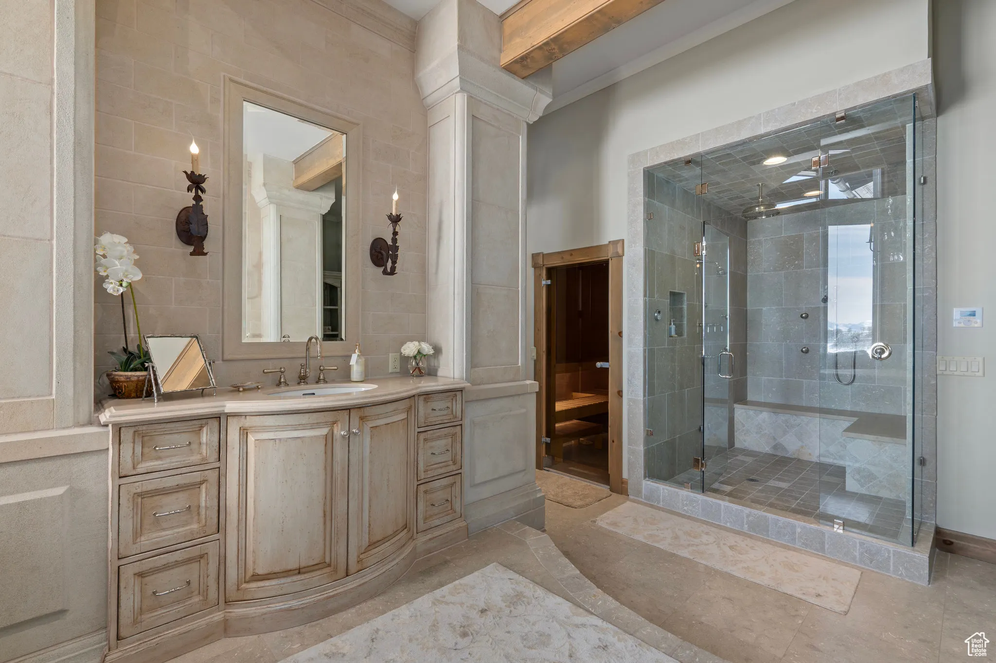 Bathroom with a stall shower, ornamental molding, tile walls, and vanity