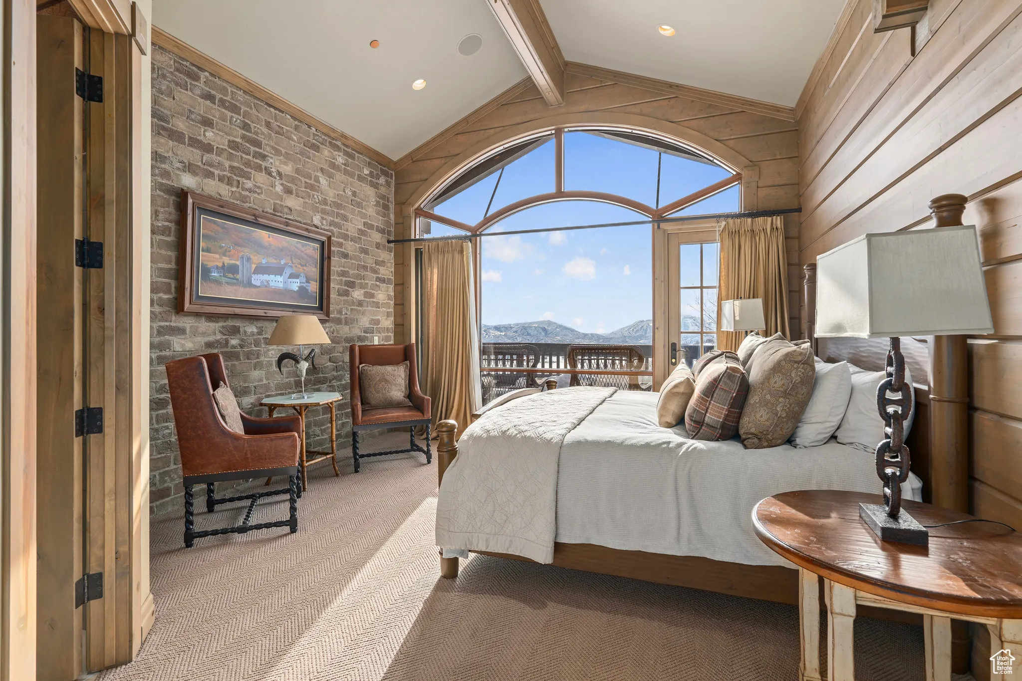 Bedroom with high vaulted ceiling, a mountain view, brick wall, carpet flooring, and beamed ceiling