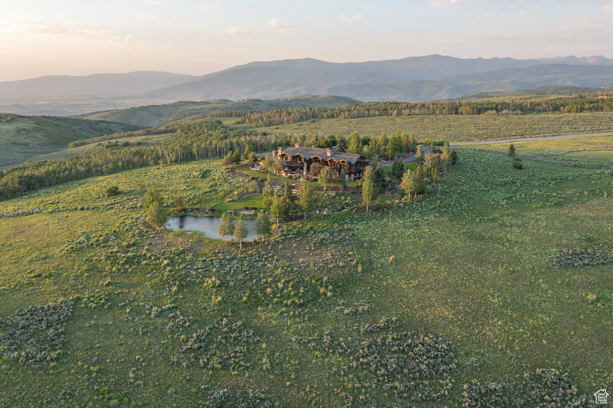 Aerial overview of property's location with a water and mountain view and rural landscape