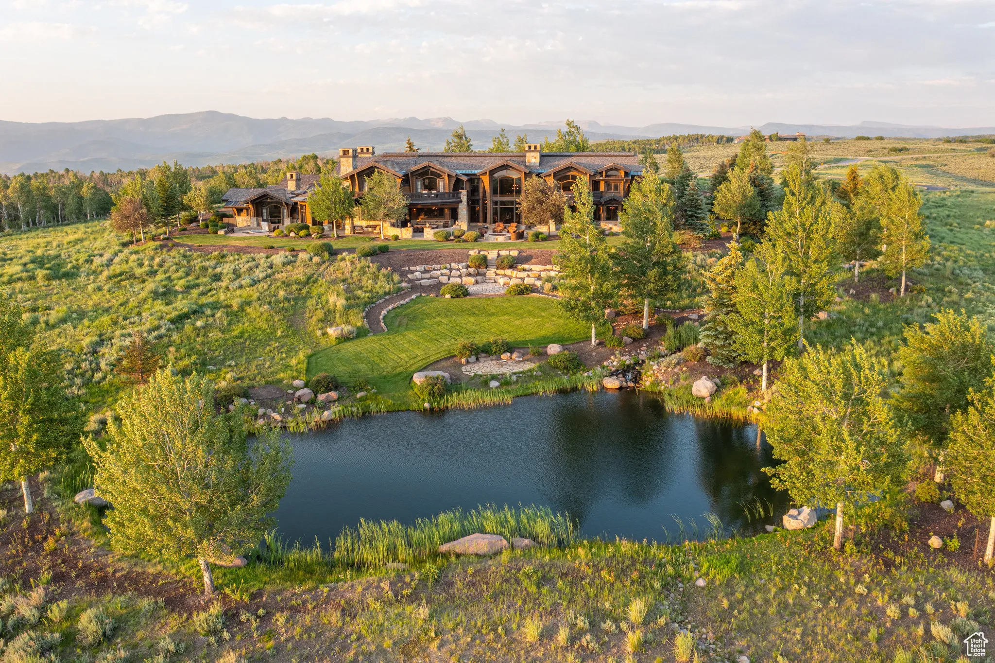 Aerial view of property and surrounding area featuring a water and mountain view